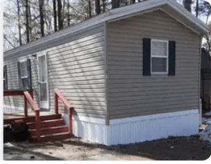 Mobile home exterior with new skirting after installation