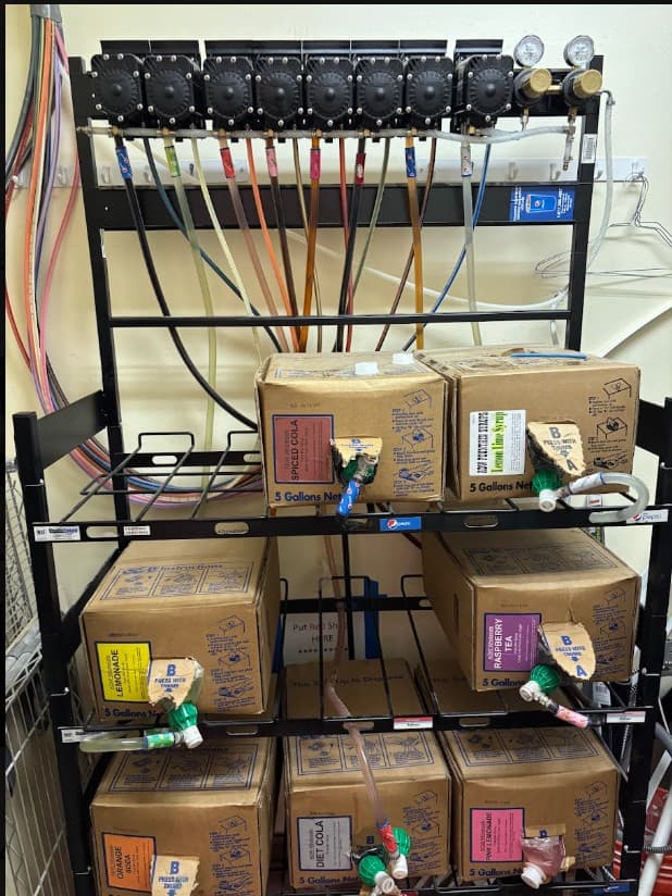 Commercial soda fountain syrup rack and beverage line setup